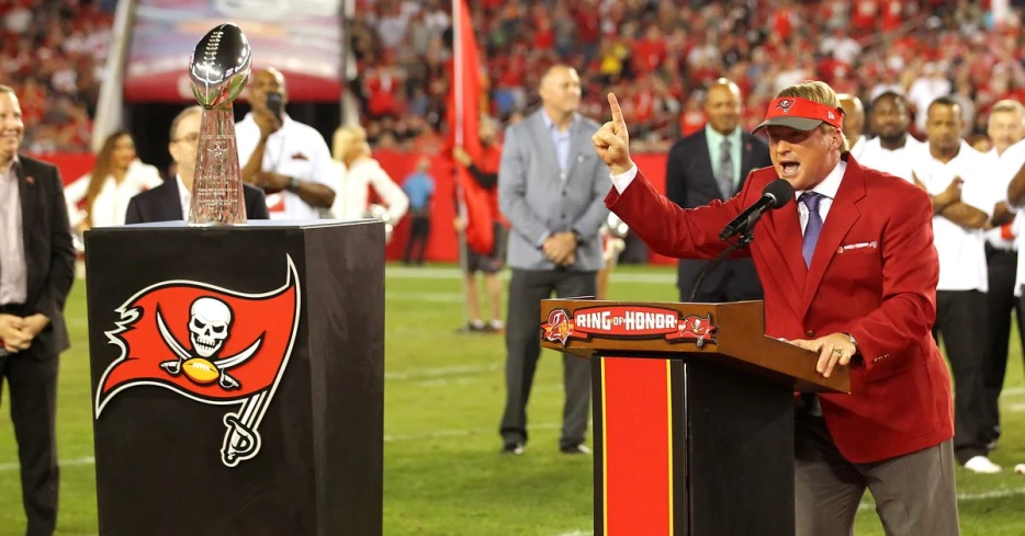 Former Bucs head coach Jon Gruden receives a 1976 jersey from the team