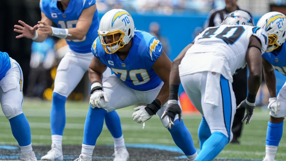 Rashawn Slater reports to training camp as contract talks continue